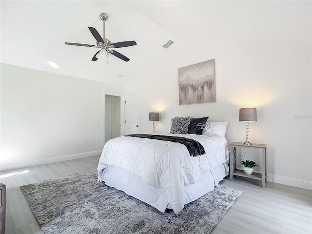 bedroom with lofted ceiling, hardwood / wood-style flooring, and ceiling fan