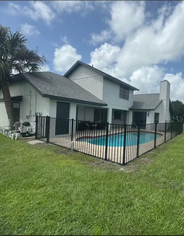 view of swimming pool with a patio and a yard