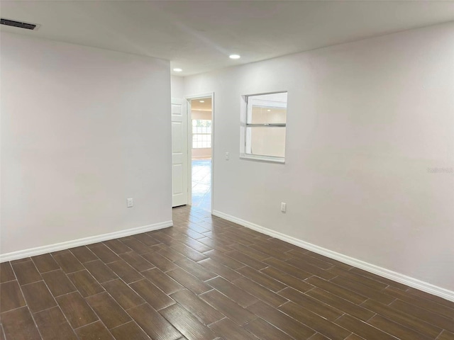 empty room featuring dark hardwood / wood-style flooring