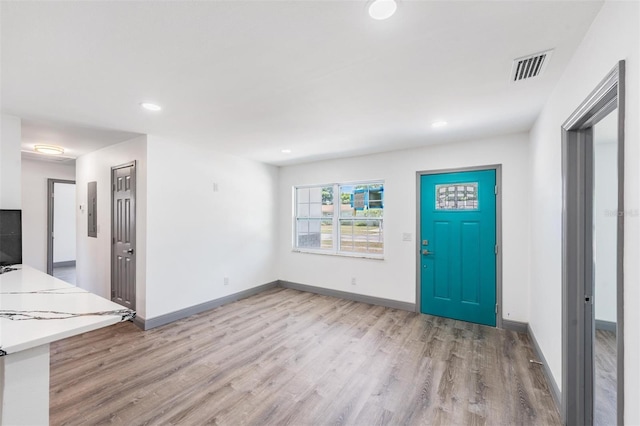 foyer entrance featuring light hardwood / wood-style floors and electric panel