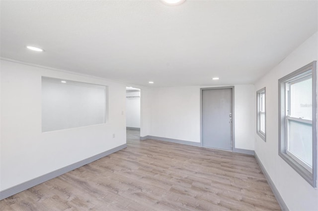 spare room featuring light wood-type flooring