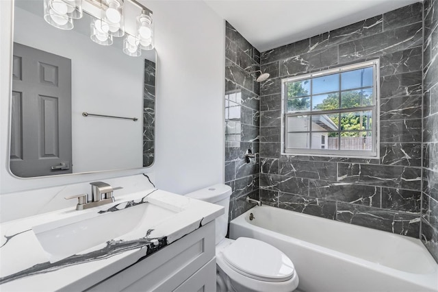 full bathroom with tiled shower / bath, vanity, a chandelier, and toilet