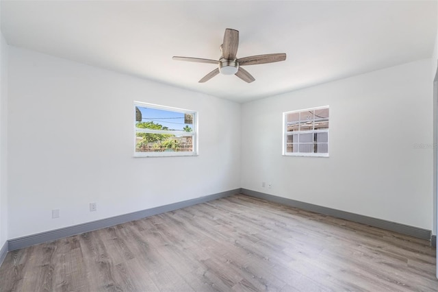 empty room featuring light hardwood / wood-style flooring and ceiling fan