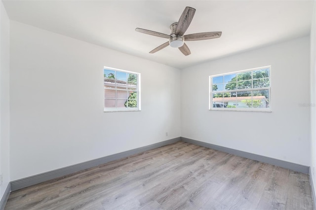 spare room featuring ceiling fan and light hardwood / wood-style floors