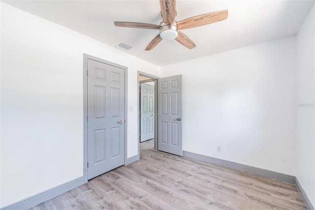 unfurnished bedroom featuring light wood-type flooring and ceiling fan