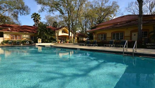 view of swimming pool featuring a patio area