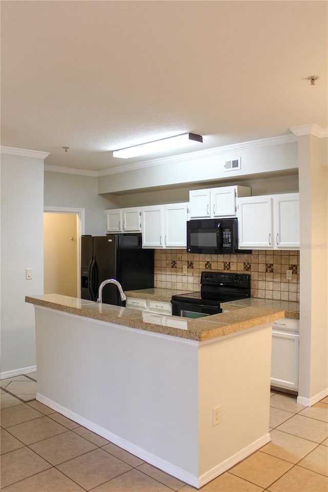 kitchen with tasteful backsplash, crown molding, black appliances, light tile patterned floors, and white cabinets