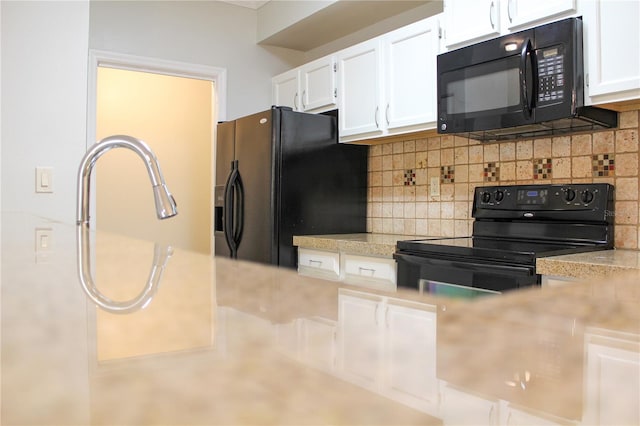 kitchen with black appliances, white cabinetry, and tasteful backsplash