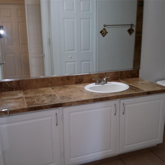 bathroom with tile patterned floors and vanity