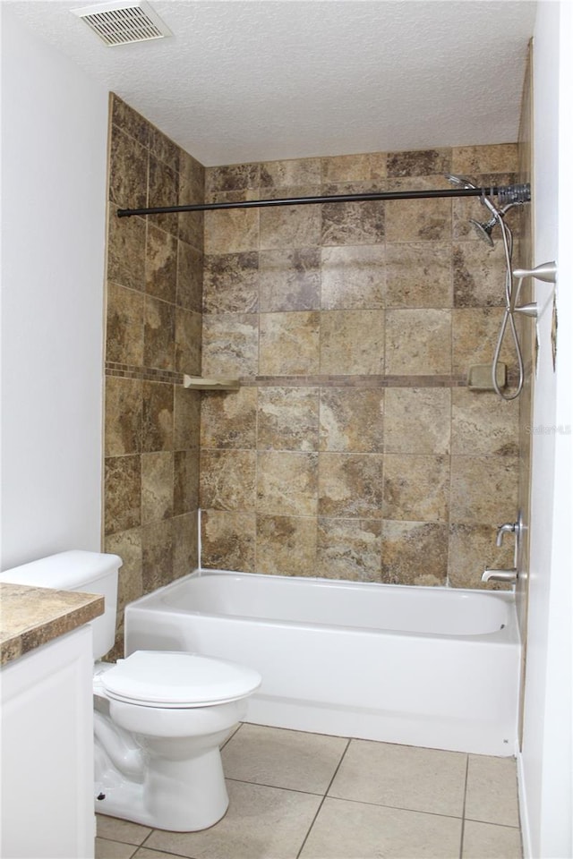 full bathroom with tile patterned flooring, vanity, toilet, and a textured ceiling