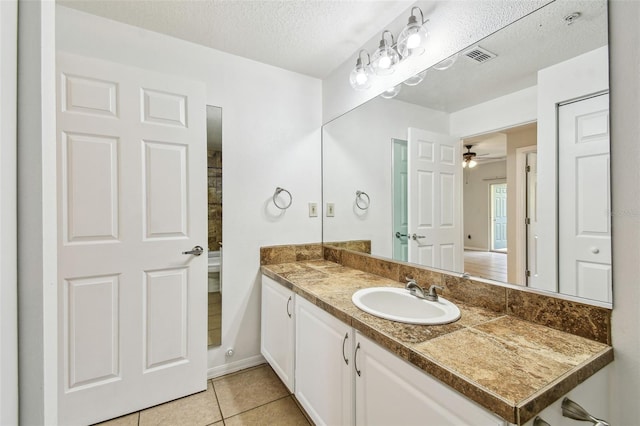 5608 Pinnacle Heights Cir Unit 305, Tampa, FL 33624 - bathroom featuring vanity, tile patterned floors, a textured ceiling, baseboards, and ceiling fan