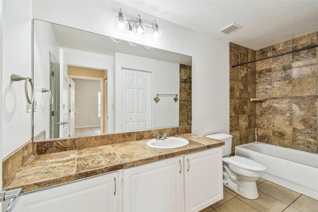 5608 Pinnacle Heights Cir Unit 305, Tampa, FL 33624 - full bath featuring toilet, a textured ceiling, vanity, shower / tub combination, and tile patterned floors