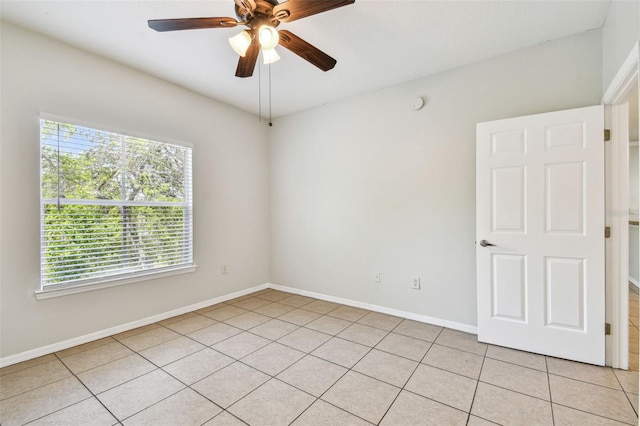 5608 Pinnacle Heights Cir Unit 305, Tampa, FL 33624 - spare room featuring light tile patterned flooring, ceiling fan, and baseboards
