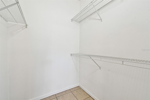 5608 Pinnacle Heights Cir Unit 305, Tampa, FL 33624 - walk in closet with light tile patterned floors