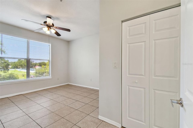 5608 Pinnacle Heights Cir Unit 305, Tampa, FL 33624 - spare room featuring a ceiling fan, baseboards, and light tile patterned flooring