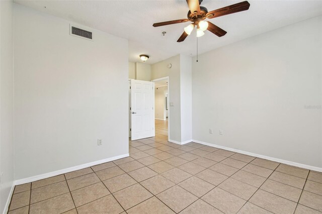 5608 Pinnacle Heights Cir Unit 305, Tampa, FL 33624 - empty room featuring light tile patterned floors, a ceiling fan, and baseboards