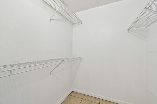 5608 Pinnacle Heights Cir Unit 305, Tampa, FL 33624 - walk in closet featuring light tile patterned floors