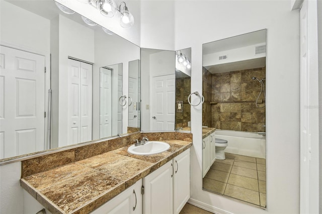 5608 Pinnacle Heights Cir Unit 305, Tampa, FL 33624 - bathroom featuring vanity, toilet, tile patterned floors, washtub / shower combination, and a closet