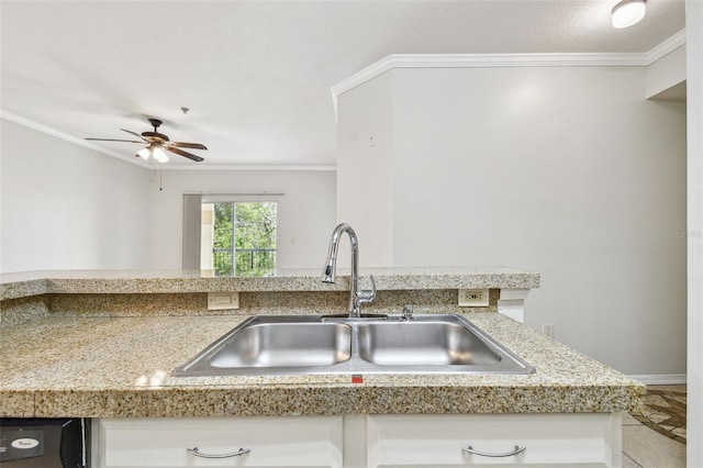 5608 Pinnacle Heights Cir Unit 305, Tampa, FL 33624 - kitchen with a sink, crown molding, ceiling fan, white cabinetry, and baseboards