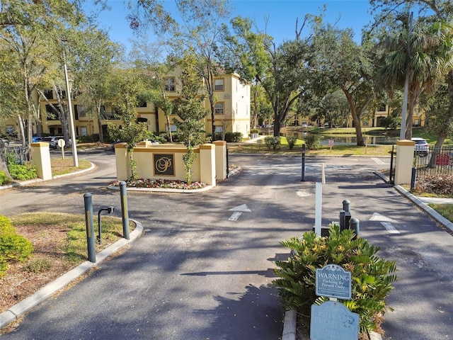 5608 Pinnacle Heights Cir Unit 305, Tampa, FL 33624 - view of asphalt road with curbs and a gated entry