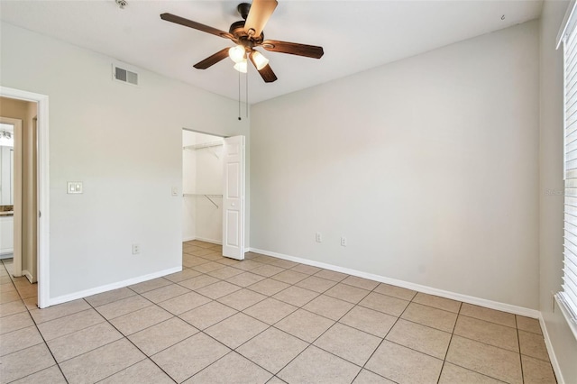 5608 Pinnacle Heights Cir Unit 305, Tampa, FL 33624 - unfurnished bedroom with a closet, light tile patterned flooring, baseboards, and ceiling fan