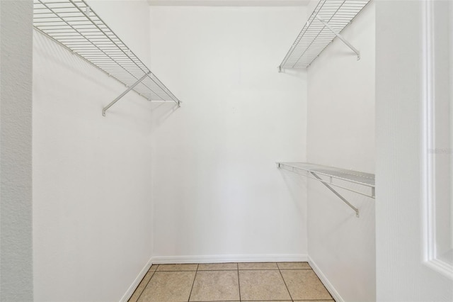 5608 Pinnacle Heights Cir Unit 305, Tampa, FL 33624 - walk in closet featuring light tile patterned flooring