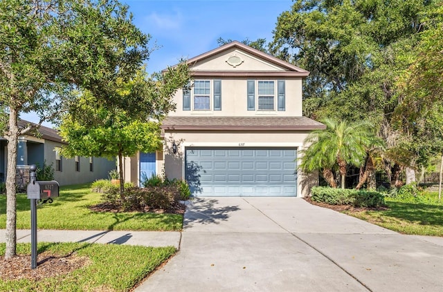 view of front property featuring a front yard and a garage