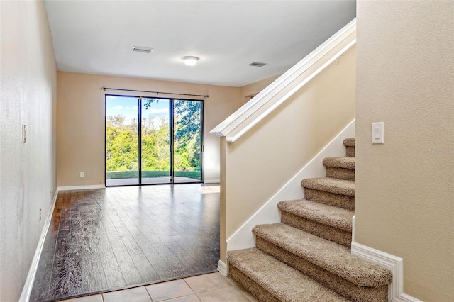 staircase with hardwood / wood-style flooring