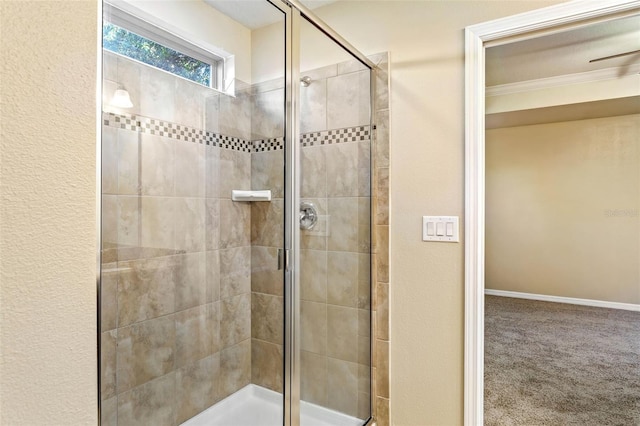 bathroom featuring ornamental molding and a shower with door