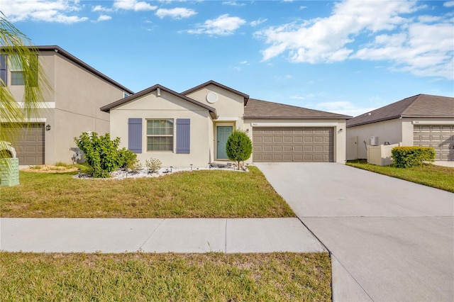 ranch-style house featuring a garage and a front lawn