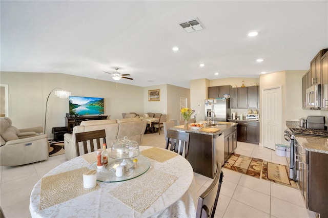 dining room with light tile patterned flooring, sink, and ceiling fan