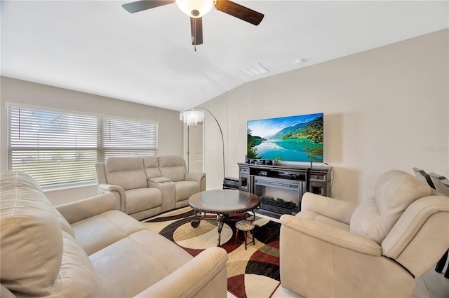 living room with ceiling fan and vaulted ceiling