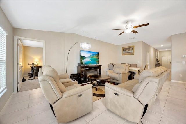 living room featuring ceiling fan, plenty of natural light, and light tile patterned floors