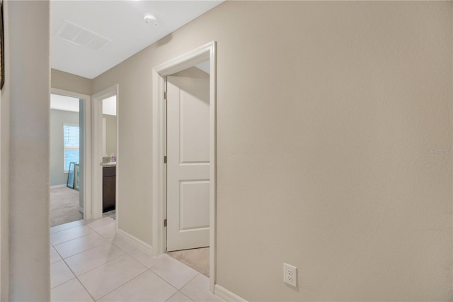 hallway featuring light tile patterned flooring