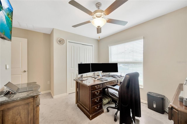 office space with ceiling fan and light carpet