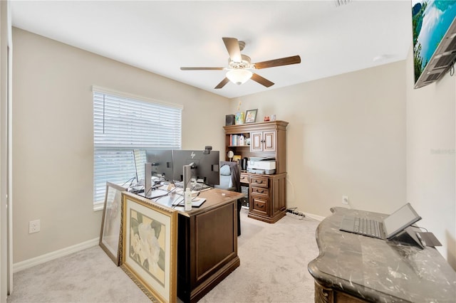 carpeted office space featuring ceiling fan