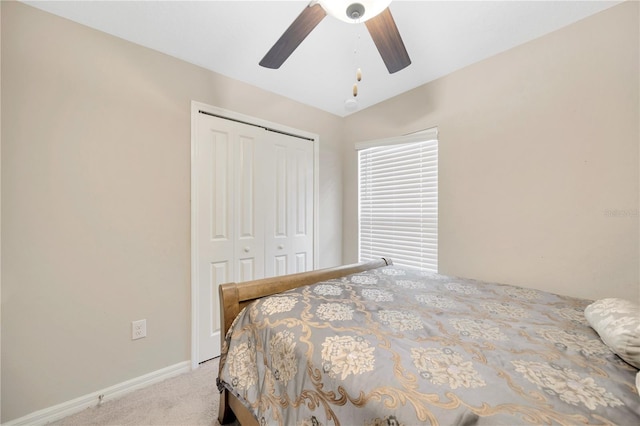 carpeted bedroom with lofted ceiling, ceiling fan, and a closet