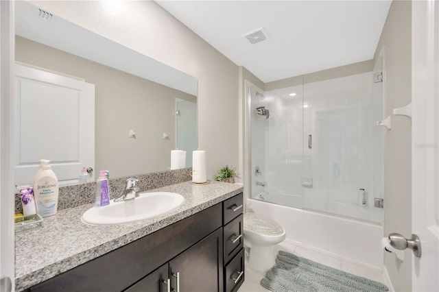 full bathroom featuring combined bath / shower with glass door, vanity, toilet, and tile patterned flooring