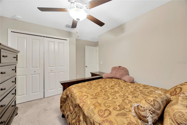 carpeted bedroom with ceiling fan and a closet