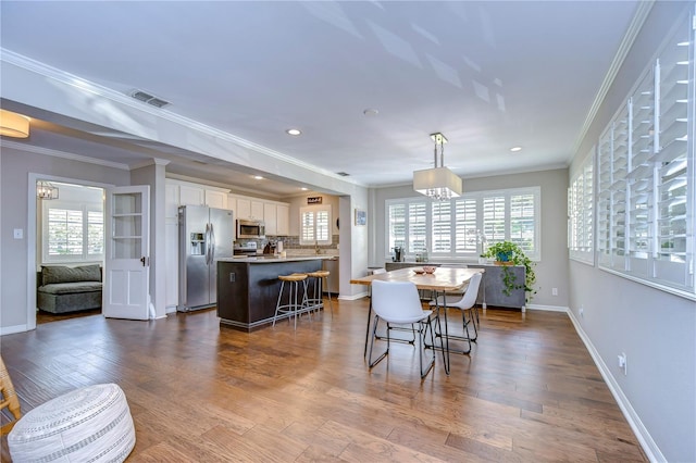 dining space featuring wood-type flooring and a wealth of natural light