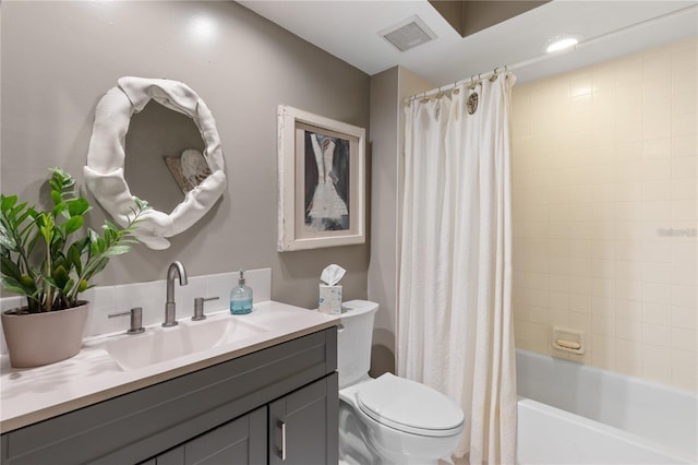 full bathroom featuring shower / bath combo, vanity, and toilet