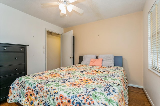 bedroom with wood-type flooring, ceiling fan, and a textured ceiling