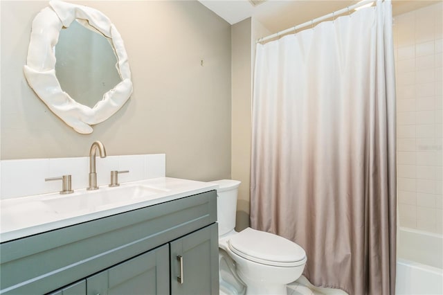 full bathroom featuring vanity, shower / bath combination with curtain, and toilet