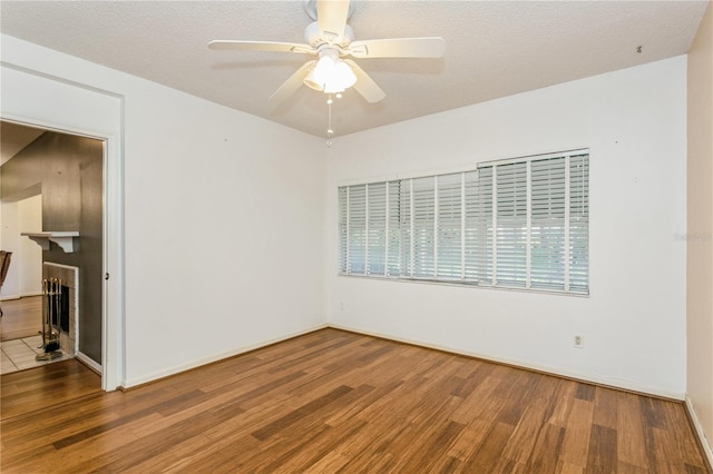 unfurnished room featuring hardwood / wood-style flooring, a textured ceiling, and ceiling fan