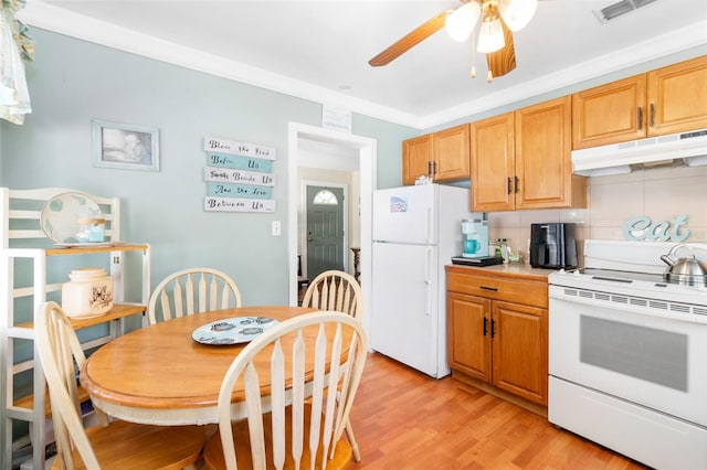 kitchen featuring decorative backsplash, light wood-style flooring, white appliances, a ceiling fan, and under cabinet range hood