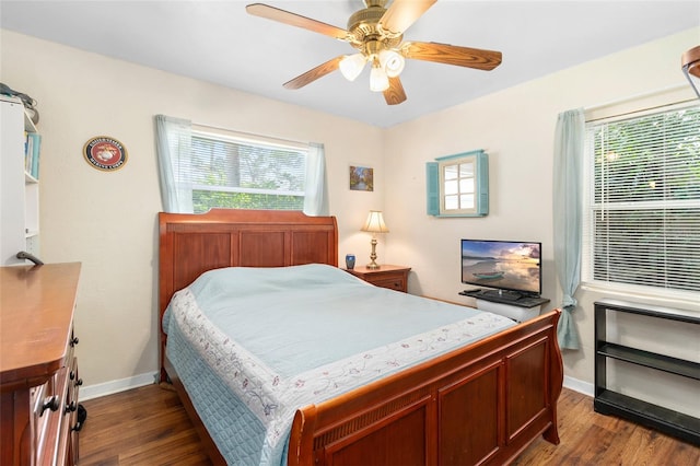bedroom featuring a ceiling fan, dark wood-type flooring, and baseboards