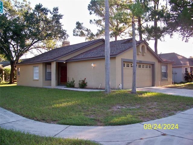 exterior space with a front yard and a garage