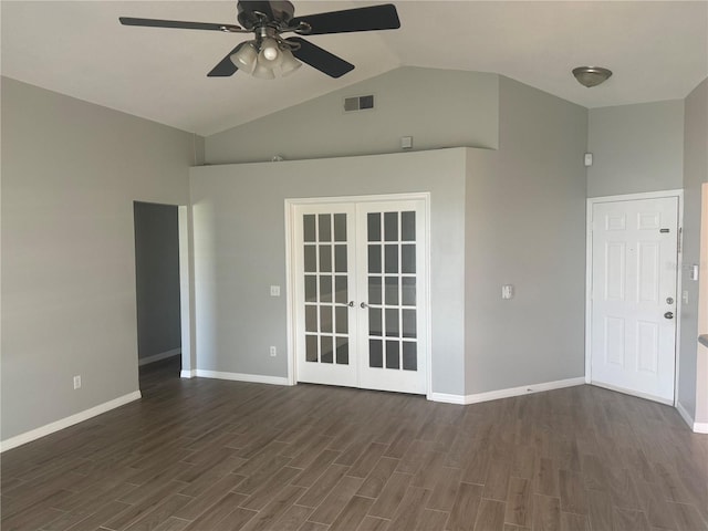 empty room featuring vaulted ceiling, ceiling fan, dark hardwood / wood-style floors, and french doors