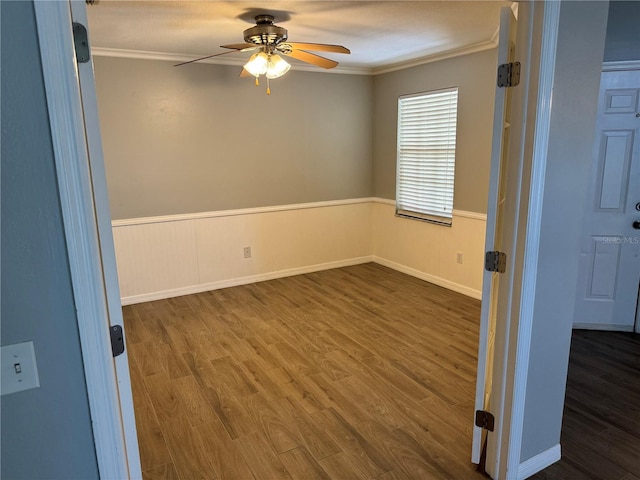 unfurnished room with ornamental molding, dark hardwood / wood-style flooring, and ceiling fan