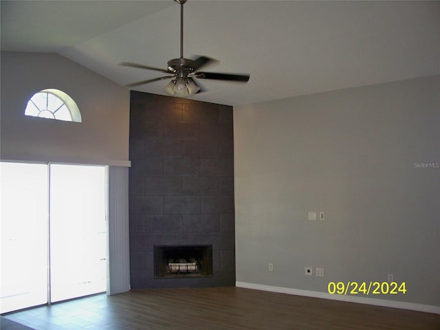 unfurnished living room with lofted ceiling, ceiling fan, hardwood / wood-style flooring, and a fireplace